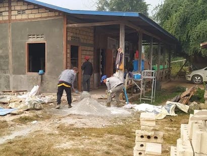 Twee mannen zijn bezig met de bouw van een ziekenhuis