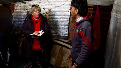Tineke met boek in haar hand in Libanon en met jonge man in gesprek