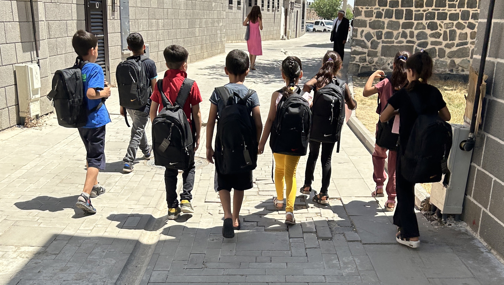 Groep kinderen met nieuwe schooltassen