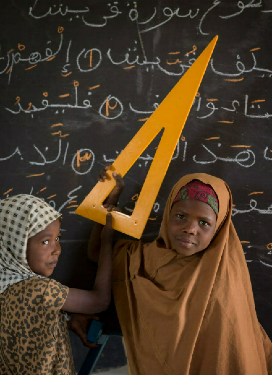 Twee leerlingen in klaslokaal met grote gele geodriehoek