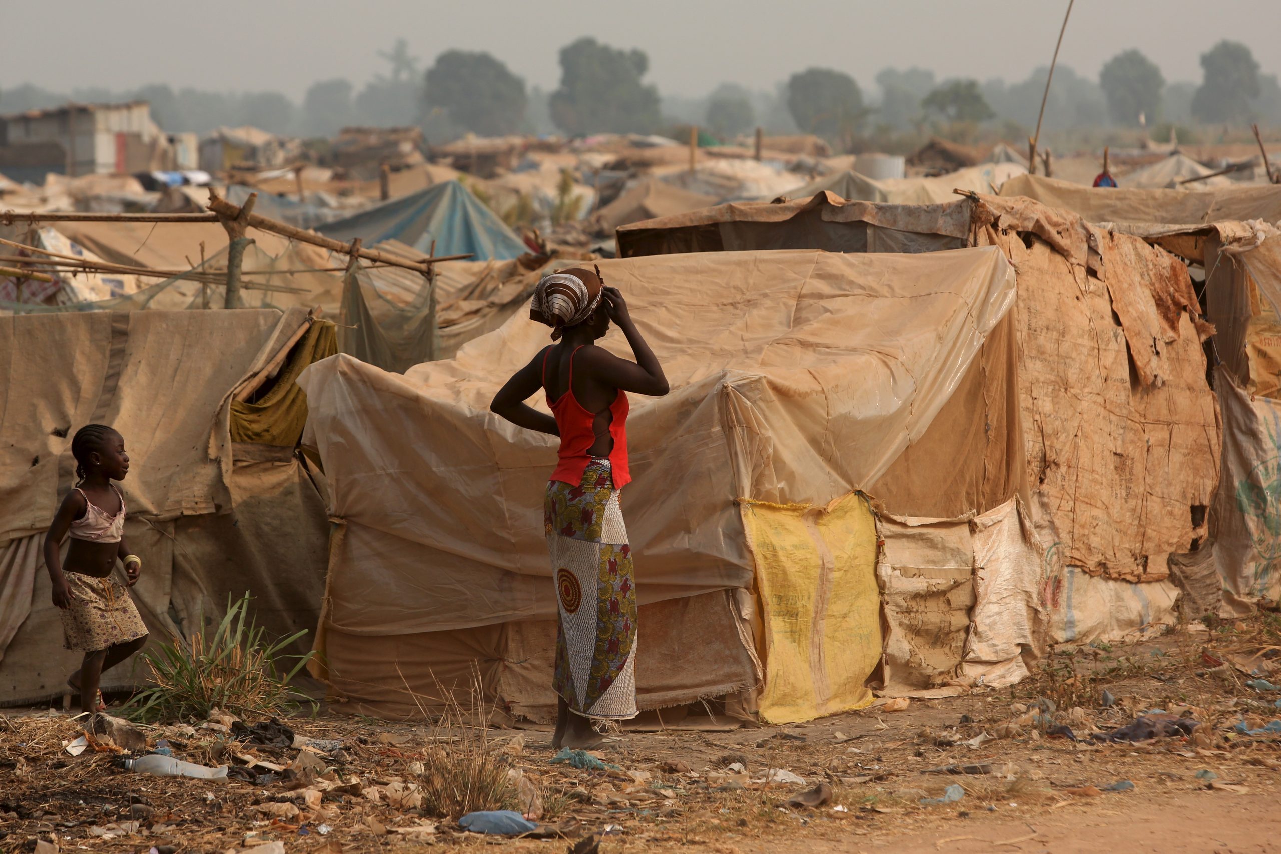 Een vrouw en een meisje kijken uit over een vluchtelingenkamp in de Centraal-Afrikaanse Republiek.
