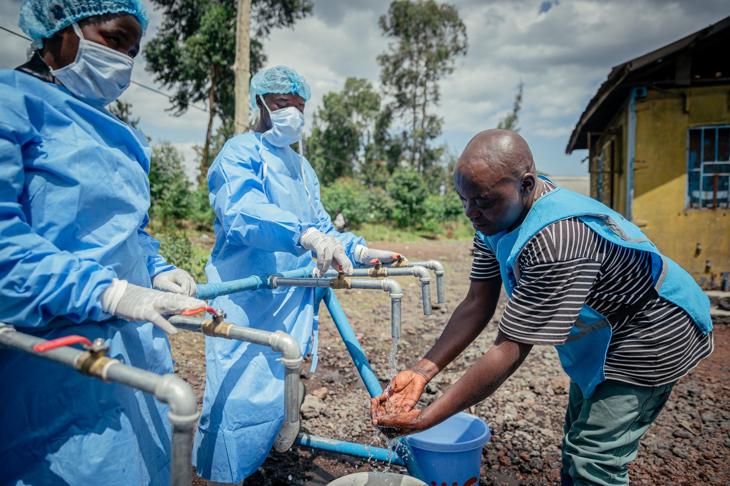 een man wast zijn handen bij een hulppunt in Goma, DR Congo